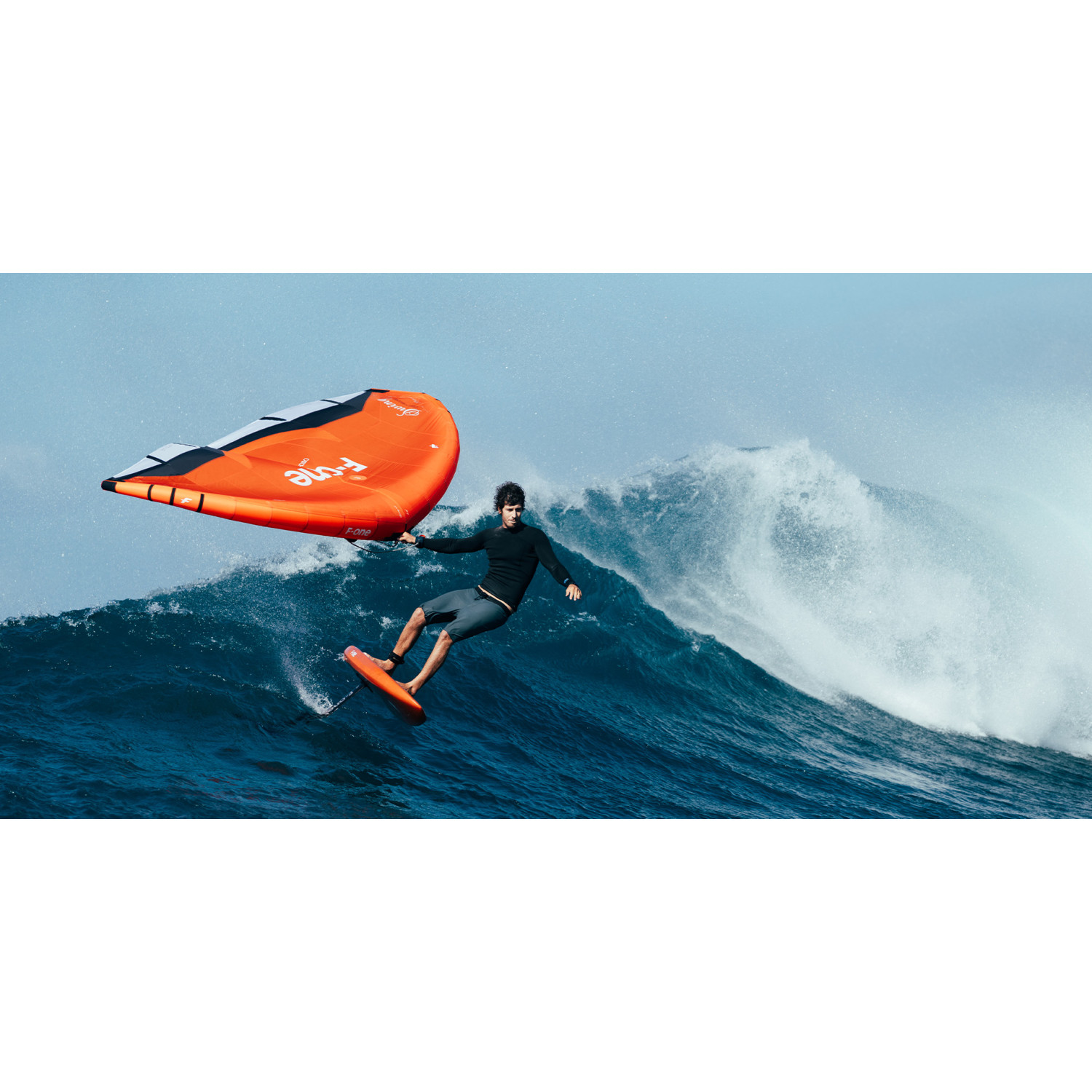 Rider wingfoiling on a wave with F-ONE gear